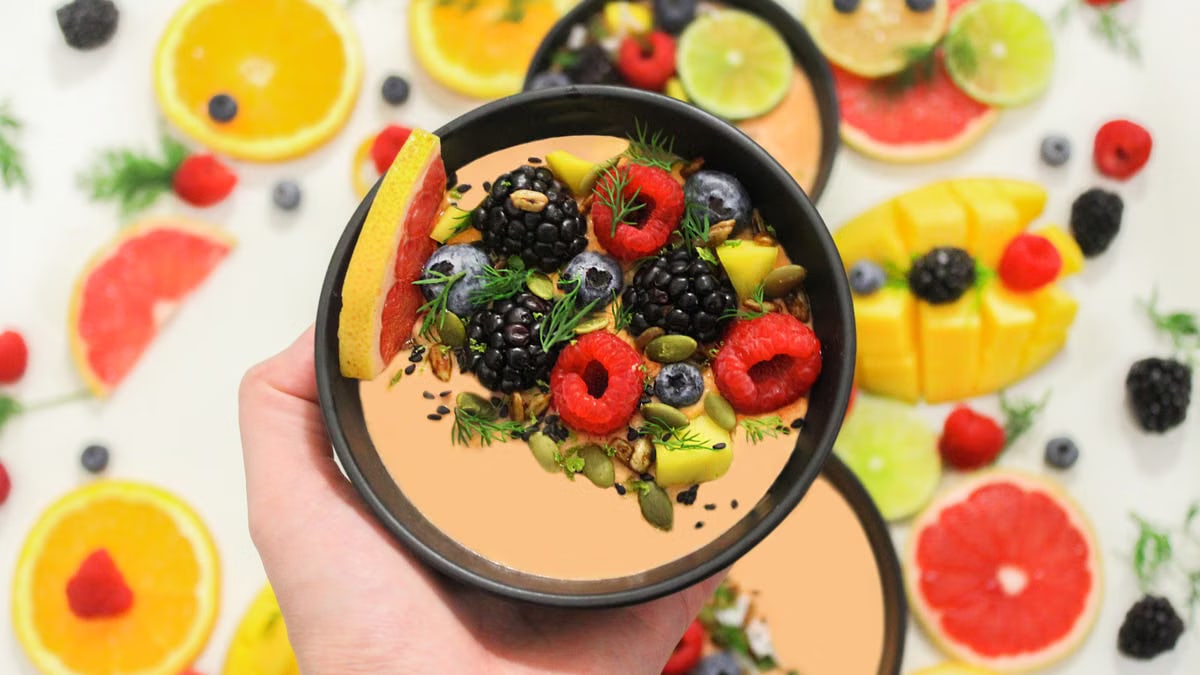 Colorful bowl of fresh fruits with a mix of berries and seeds, perfect for a healthy meal.